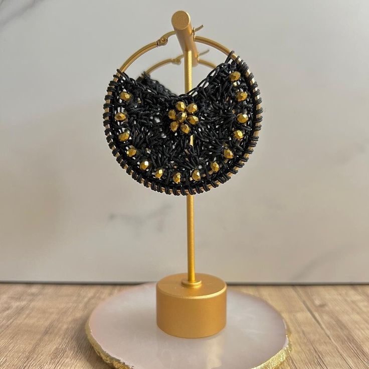 Embrace sophistication and individuality with our handcrafted macramé earrings, embellished with beads and brass. Featuring a serene blend of black and gold, each piece exudes tranquil elegance. With a diameter of 2.4 inches, these earrings are meticulously crafted to make a statement. Elevate your style with these artisanal treasures, lovingly made to enhance your unique beauty." Adjustable Macrame Earrings For Jewelry Making, Festival Adjustable Macrame Beaded Earrings, Adjustable Macrame Beaded Earrings For Festival, Adjustable Macrame Earrings, Traditional Macrame Earrings, Adjustable Macrame Beaded Earrings, Adjustable Bohemian Beaded Wrap Earrings, Handwoven Black Earrings For Gifts, Gold Macrame Earrings For Festival