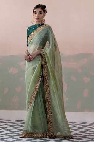 Green pure tissue silk saree with a sequin and thread hand embroidered border. Paired with a padded blouse with back tassel tie-up and petticoat. - Aza Fashions Transitional Festive Pre-draped Saree With Embroidered Border, Pista Green Chanderi Blouse Piece For Reception, Green Art Silk Pre-draped Saree With Embroidered Border, Embroidered Pista Green Pre-draped Saree For Reception, Elegant Cotton Silk Pre-draped Saree With Embroidered Border, Transitional Embroidered Organza Pre-draped Saree, Designer Green Pre-draped Saree With Embroidered Border, Embroidered Organza Blouse For Diwali, Festive Pista Green Chanderi Pre-draped Saree