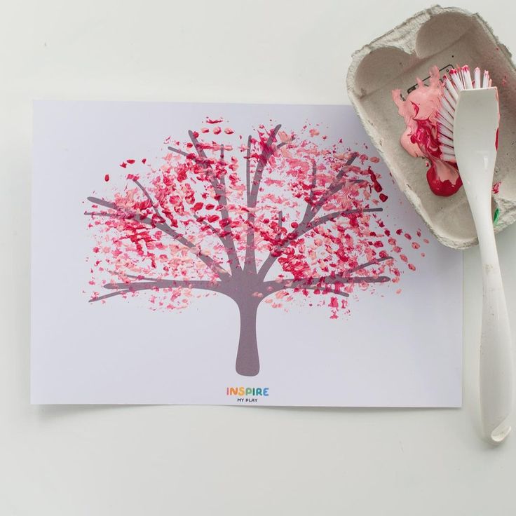 a paper plate with a spoon next to a tree cut out on it and a card