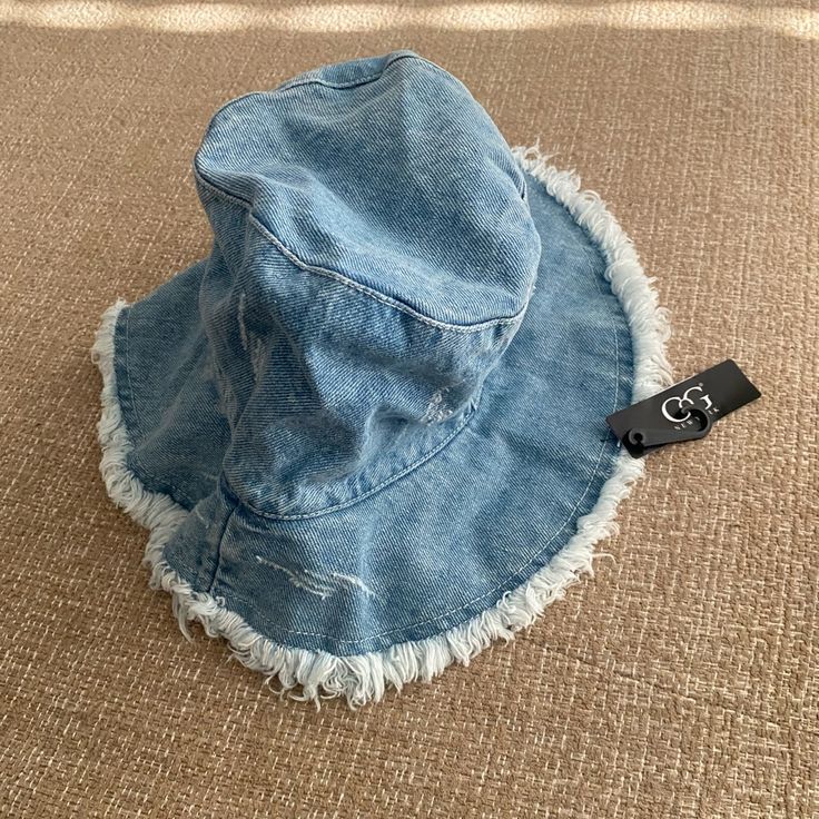 a blue jean hat sitting on top of a carpet