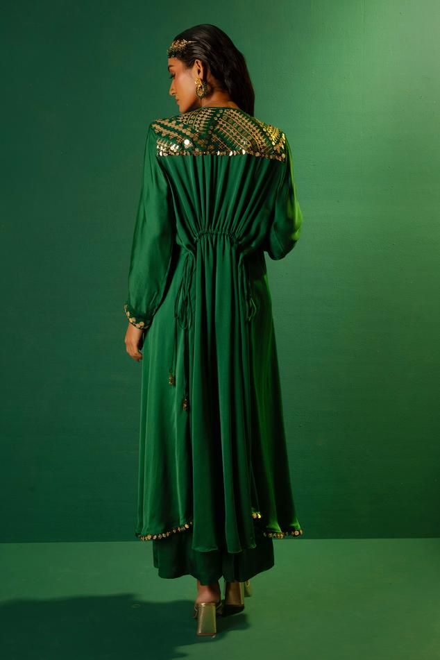 Emerald green placement sequin mirror hand embroidered kurta with high-low hem. Paired with a palazzo.
Components: 2
Pattern: Hand Embroidery
Type Of Work: Sequins
Neckline: Round Neck
Sleeve Type: Full Sleeves
Fabric: Satin
Color: Green
Other Details: 
Note: All the jewellery, belt and potli bag shown in the image is not for sale
Occasion: Sangeet - Aza Fashions Festive Anarkali Kaftan With Sequins, Green Embellished Kaftan For Festivals, Embellished Green Dress For Navratri, Festive Designer Kaftan With Sequins, Anarkali Style Sequined Kaftan For Party, Green Sequined Straight Kurta, Embellished Maxi Length Sharara For Eid, Festive Green Sequined Kurta, Bollywood Style Embellished Green Kaftan