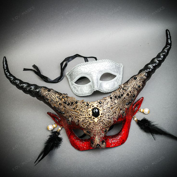 two masquerade masks with black and red feathers