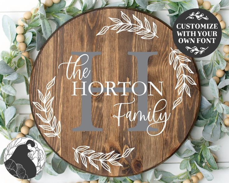 a wooden sign that says i love the horton family with leaves and berries around it