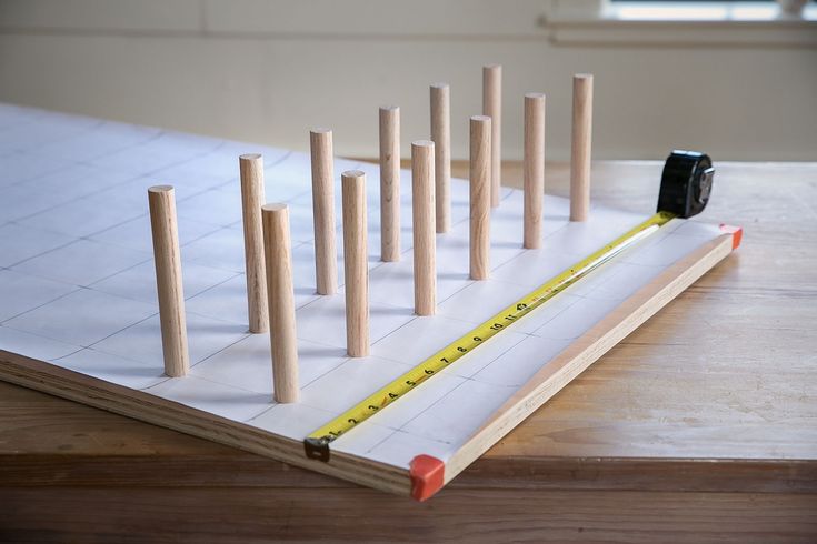 a tape measure is placed on top of a piece of paper with wooden dows