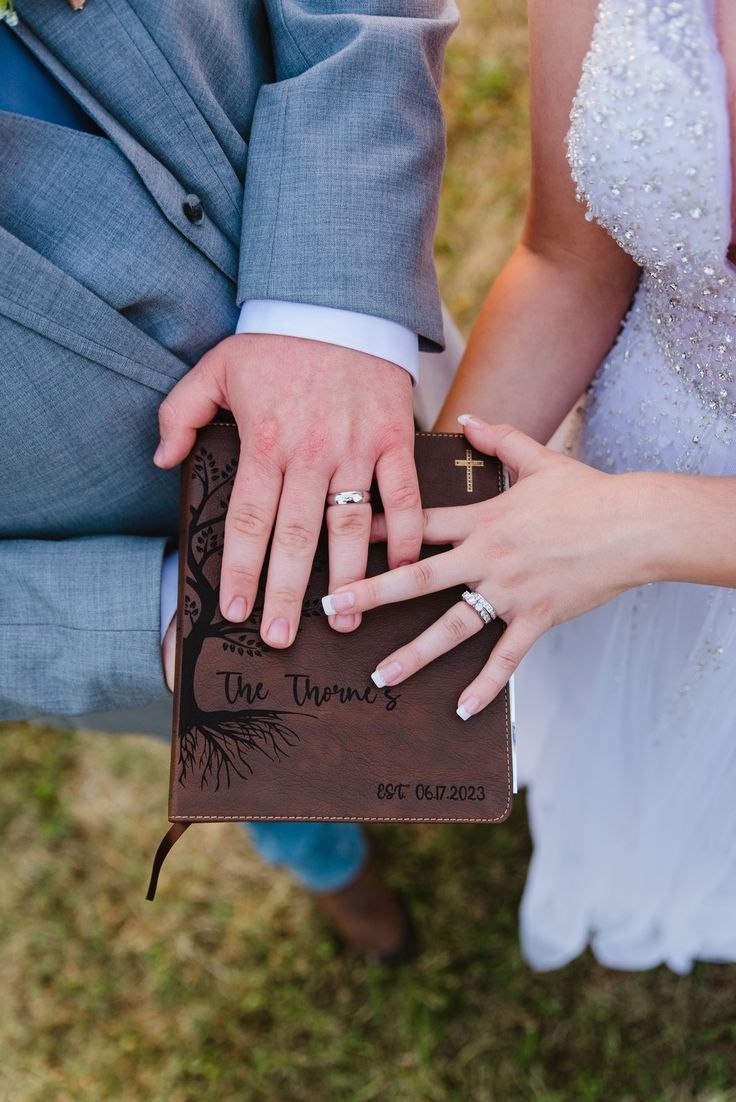 a bride and groom hold their hands together