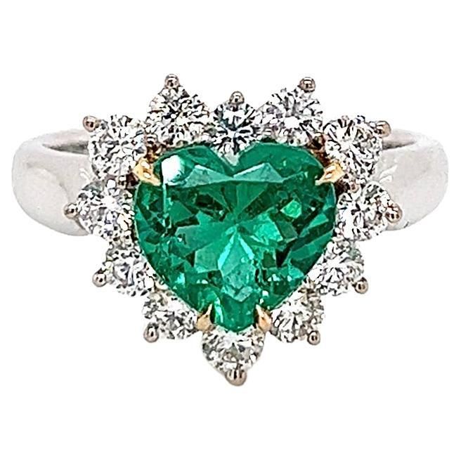 a heart shaped emerald and diamond ring