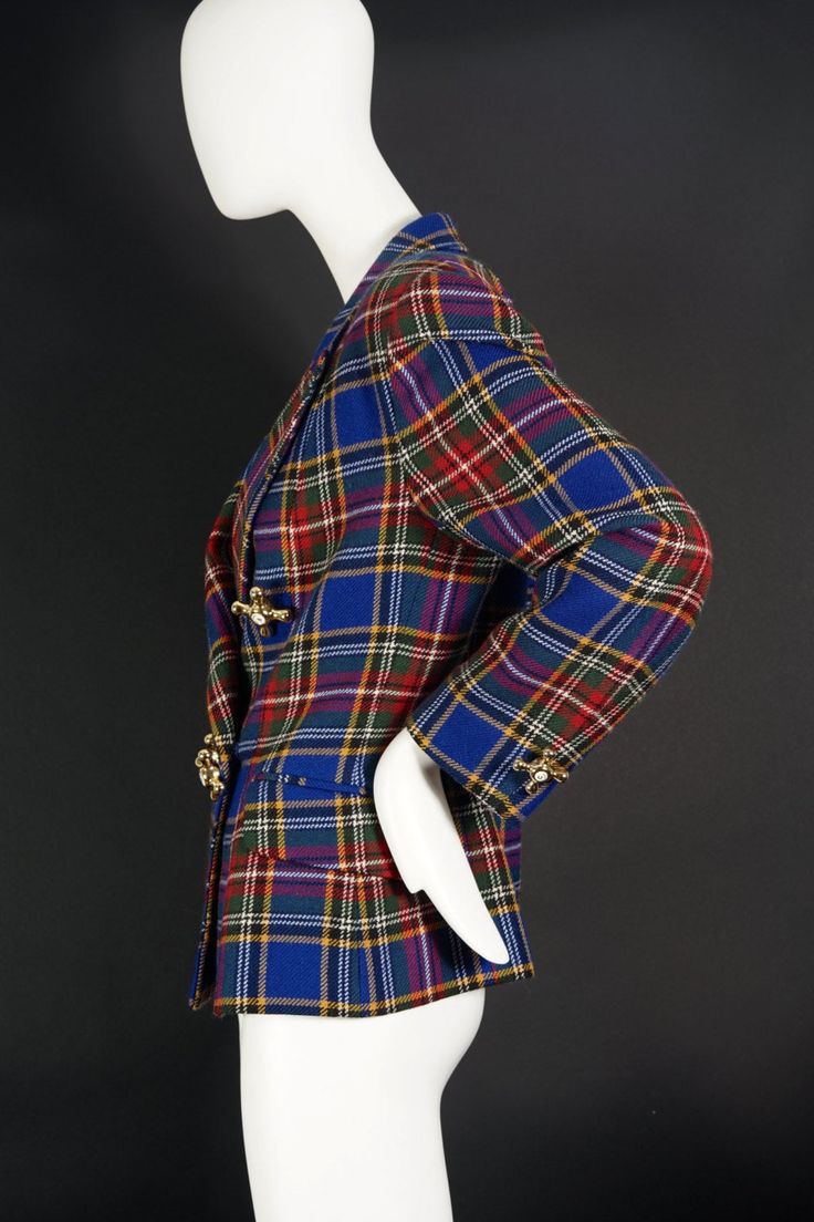 Features: - 100% Authentic MOSCHINO. - Tartan/ plaid/ checkered tweed jacket. - Faucet novelty buttons with F (Froid/ Cold) and C (Chaud/ Hot). - Decorative flap pockets at the front. - Fully lined and slightly padded shoulders. - Label reads: CHEAP and CHIC by MOSCHINO Made in Italy. - Size Tag: I46, D42, F42, GB14, USA 12. - Fabric Content: 100% Wool. - Excellent vintage condition. Measurements taken laid flat, please double bust and waist: Shoulder: 18 inches Sleeves: 22 inches Bust: 20 inche Classic Plaid Tweed Jacket With Buttons, Plaid Wool Blazer With Buttons, Fall Plaid Blazer With Buttons, Vintage Plaid Tweed Jacket, Plaid Tweed Blazer With Button Closure, Winter Plaid Blazer With Buttons, Retro Plaid Tweed Jacket For Fall, Vintage Plaid Tweed Blazer, Vintage Tweed Plaid Blazer