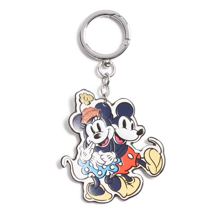 a mickey and minnie mouse keychain is shown on a white background with an image of the same character