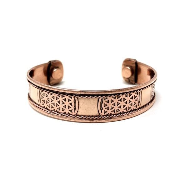 a copper bracelet with an intricate design on it