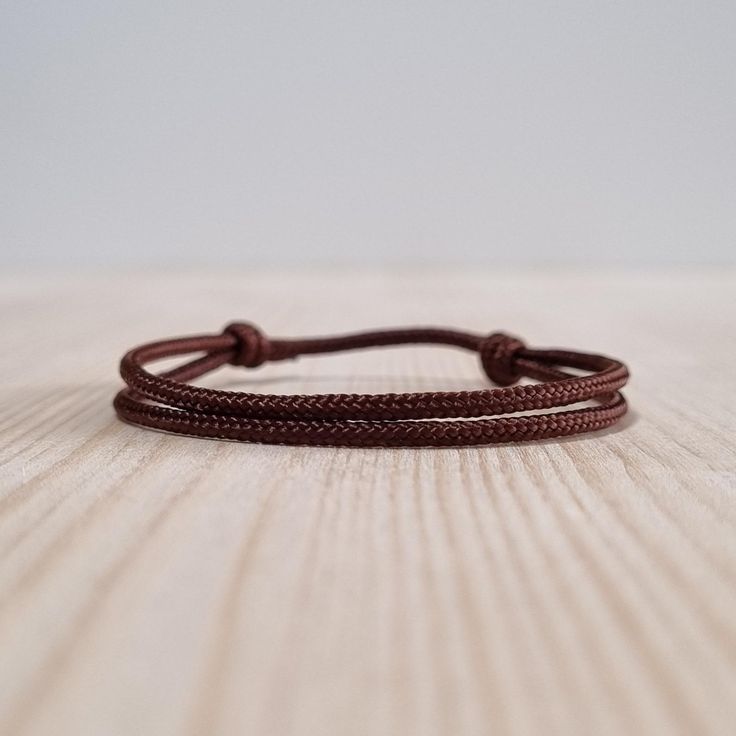 Simple brown string bracelet, made from a nylon cord.  The bracelet has an adjustable size thanks to the sliding knot. This a simple fabric jewelry that can be worn alone or stacked with other bracelets. Suitable for both men and women. The bracelet is fully water-resistant, so you can swim and shower with it. - - - - - - - - - - Materials: Nylon cord  - Cord diameter: 2mm - Color: Brown - - - - - - - - - Sizes: S - Fully Closed - 5.9"inches (15cm) / Full Opened - 11.8"inches (30cm) M - Fully Cl Casual Braided Bracelets With Adjustable Length, Adjustable Nylon Cord Friendship Bracelets, Casual Nylon Cord Friendship Bracelets As Gift, Casual Nylon Cord Friendship Bracelet As Gift, Casual Braided Bracelet With Adjustable Cord, Casual Everyday Braided Bracelet With Adjustable Cord, Minimalist Nylon Cord Friendship Bracelet With Sliding Knot, Minimalist Nylon Cord Braided Bracelet As Gift, Adjustable Nylon Cord Bracelets With Sliding Knot