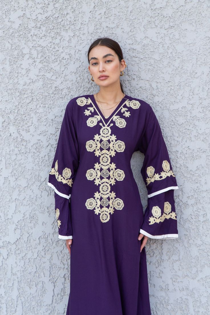 **Note : The kaftan in the video is a different color and is only displayed to show the fit, flow, and cut of the Kaftan. You will receive the one in the pictures.** Feel like royalty in this Kaftan maxi dress with its mono tone embroidery, a royal look made of extremely soft cotton, light and extremely soft and can be used on many occasions - dinners, gatherings, beach, lounge, or even in your home to feel comfortable.  Fabric : 70% Egyptian Cotton; 30% Polyester. Sizes : The dress comes in two V-neck Eid Kaftan With Dabka Work, Eid V-neck Kaftan With Dabka Work, Festive Maxi Kaftan With Resham Embroidery, Embroidered V-neck Kurta For Eid, Festive Resham Embroidery Maxi Kaftan, Festive V-neck Kaftan With Floral Embroidery, Summer Kaftan With Dabka Work, Embroidered V-neck Kaftan For Festive Occasions, Festive Embroidered V-neck Kaftan