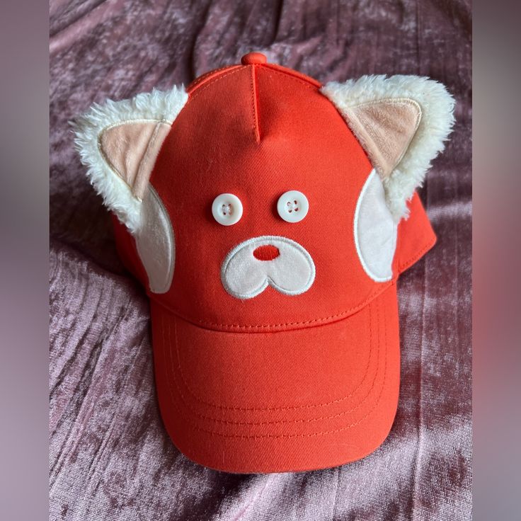 a red hat with white ears and eyes