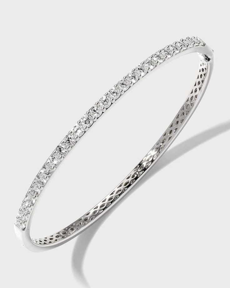 Diamond fashion bangle from Memoire..Polished 18-karat white gold hardware..26 round-cut, prong-set G-H/SI diamonds..Hinged opening with fold-over clasp..1.97 total diamond carat weight. Platinum Bangle Diamond Bracelet, Platinum Bangle Diamond Bracelet With Diamond Cut, Platinum Diamond Cut Bangle Bracelet, Luxury Brilliant Cut Bangle For Anniversary, Diamond White Diamond Bangle With Pave Setting, Diamond Bangle With Pave Setting, Diamond White Bangle With Pave Setting, Platinum Diamond Bangle Bracelet For Anniversary, White Round Bangle With Pave Setting