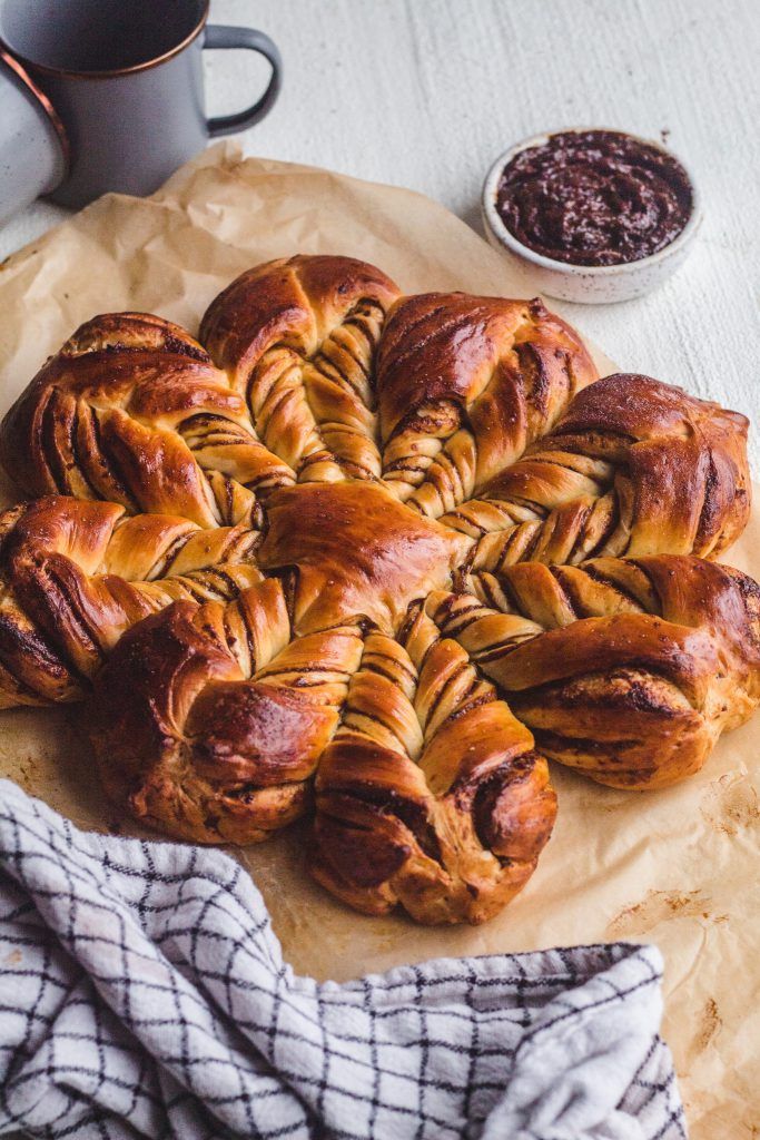 several pastries sitting on top of a piece of paper next to a cup of coffee