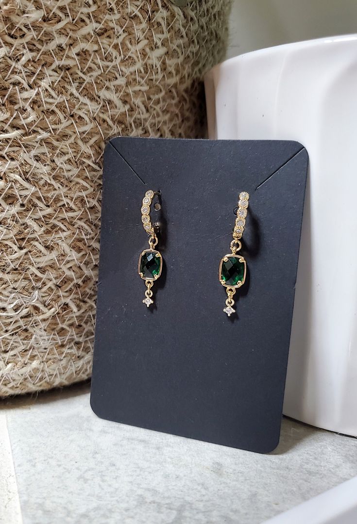 So elegant, but simple enough to be worn any day. These extremely lightweight earrings feature a beautiful emerald green glass bezel charm and a cubic zirconia paved huggie hoop. Even more beautiful in person! Total length is just over 3cm. ❤️ Handmade with love ❤️ Great for gifting Every item is handmade by me, so please understand there are no two items exactly alike. All jewelry may vary slightly from how they are pictured, but I try my best to take accurate pictures and make them all the same. Most metals will tarnish eventually, but there are things you can do to keep your jewelry looking great for as long as possible. Avoid spraying with perfumes or wearing in the shower. Storing your earrings in the plastic bag they arrive in will slow down the tarnishing process and keep them looki Elegant Hoop Earrings For May Birthstone, May Birthstone Crystal Drop Earrings, Minimalist Single Green Earring, Emerald Earrings For Everyday May Birthstone, Emerald Earrings For Everyday And May Birthstone, Elegant Small Hoop Green Earrings, Elegant Green Hoop Earrings, Green Minimalist Drop Earrings, Elegant Green Dangle Hoop Earrings