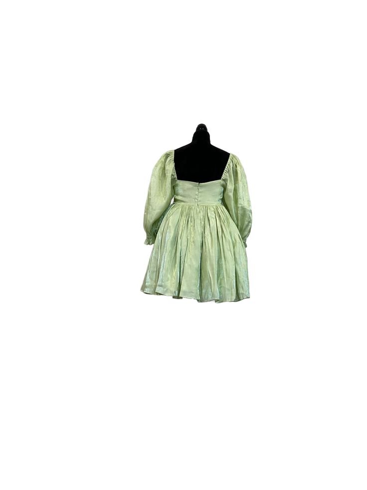 Light Green Babydoll Dress Just like the flutter and glimmer of a fairy's wings, this shimmery dress gracefully sways and bounces, bestowing you with magical essence. This babydoll dress features a luscious green satin fabric that shimmers in the light. The puffy 3/4 sleeves and bouncy skirt give movement to every step you take. The skirt of this dress is extra voluminous with three layers, while the top is double-layered for coverage. The innermost layer of this dress is sewn to hide the seams for the smoothest wear against your skin. It closes at the back with an invisible zipper. Dress is approximately 32" in length. Model is 5'2, wearing a size small. Green Babydoll Dress, Green Satin Fabric, Shimmery Dress, Green Fairy, Zipper Dress, Every Step You Take, Fairy Wings, Green Satin, Spring Green