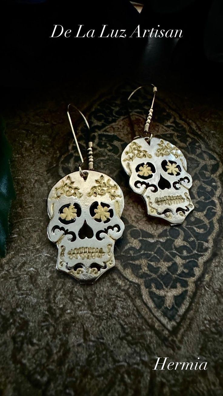 HERMIA  Materials:  Silver plated alloy, 18k Gold plated Length:  2" I hand painted the gold details of the Hermia Dia de Muertos sugar skulls.  Hanging from 18k gold kidney ear wires with gold bead detailing these are perfectly festive.  Due to the variant nature of handmade polymer clay pieces, the earrings you receive will be uniquely one of a kind & very similar to the ones shown with slight variations.  Not intended to get get.  Please do not wear in pool or shower.   Free Shipping on all o Halloween Silver Jewelry With Skull Print, Metal Skull Print Jewelry For Halloween, Silver Skull Print Jewelry For Halloween, Bohemian Skull Earrings For Gifts, Gold Skull Bohemian Jewelry, Nickel-free Skull Jewelry For Party, Nickel-free Skull Jewelry For Day Of The Dead, Halloween Skull Jewelry With Skull Print, Nickel Free Skull Jewelry For Day Of The Dead