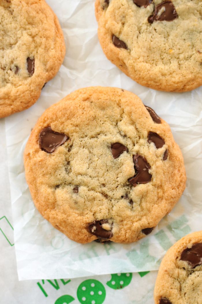 several chocolate chip cookies sitting on top of wax paper