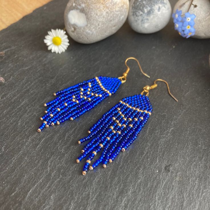 These earrings have a stunning deep and rich deep midnight blue colour and are absolutely stunning. A touch of elegance and luxury without breaking the bank. These are lightweight and would add a lovely dollop of shimmer and sparkle to enhance any outfit. These would be a perfect gift for a mum, sister, friend, girlfriend, wife. Material: Czech beads woven using durable thread. Technique: Brick stitch and fringe Ear wire: You can choose between ear hooks and clip-on fittings. I offer a choice of finishes including sterling silver 925, gold-plated, golden and silver-colour fittings to suit most needs.   Dimensions: The length stated includes the handmade beaded piece and brass component. For the drop length, add 1.2 - 1.6 cm (ear wire-dependent)  Packaging: Earrings will be wrapped in colou Elegant Blue Tassel Earrings With Beaded Fringe, Blue Long Drop Jewelry With Beaded Fringe, Blue Beaded Fringe Dangle Earrings, Blue Beaded Fringe Drop Earrings, Blue Beaded Fringe Jewelry Gift, Blue Dangle Earrings With Beaded Fringe, Blue Beaded Fringe Jewelry As A Gift, Blue Beaded Fringe Tassel Earrings As Gift, Blue Beaded Fringe Jewelry For Gifts