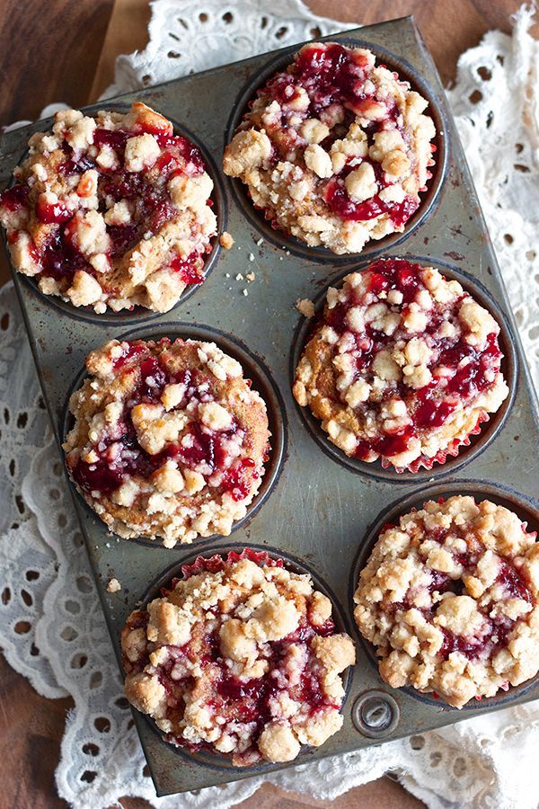 muffins with crumbled toppings sitting on a tray