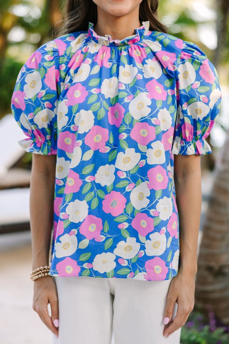 This blouse just wants you to love it! It's so fab and fun! That abstract floral print is so unique! We love the colors featured in the print too! This blouse can be styled for a day out and about town or a day at the office! High round neckline Short puff sleeves Floral abstract print No stretch Sydney is wearing the small. Spring Vacation Blue Blouse, Blue Hibiscus Print Top For Spring, Vacation Floral Print Patterned Blouse, Spring Blue Hibiscus Print Top, Blue Blouse For Spring Vacation, Blue Floral Print Tops For Vacation, Blue Floral Print Top For Day Out, Blue Floral Print Tops For Day Out, Fitted Vibrant Print Blouse For Day Out