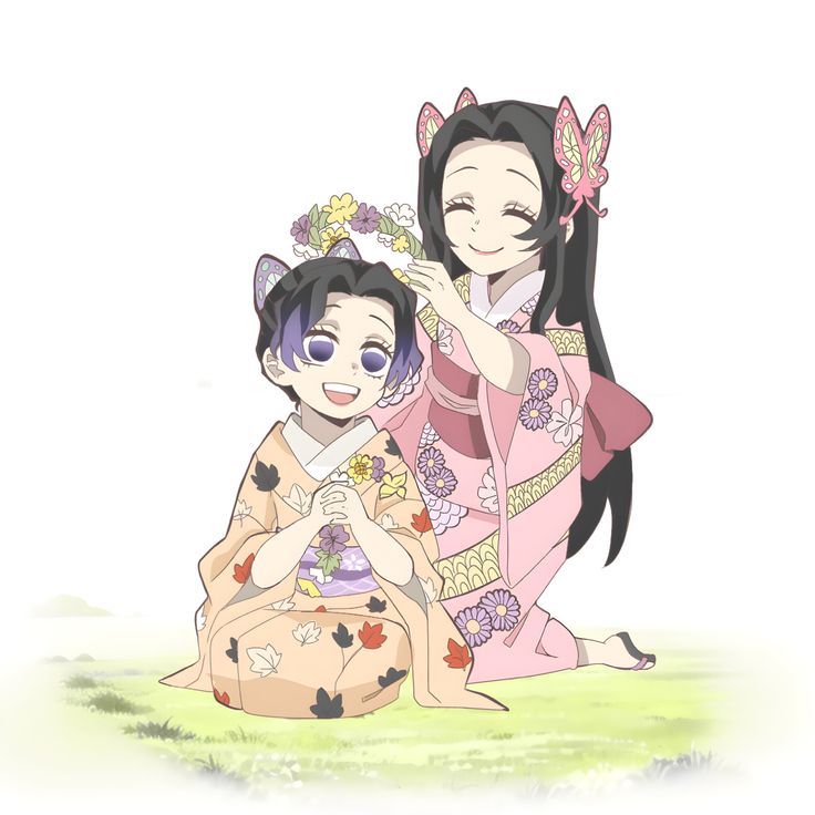 two women in kimonos sitting on the ground and one is holding her hand up