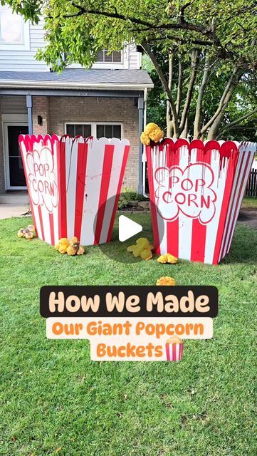 two large popcorn buckets sitting in the grass