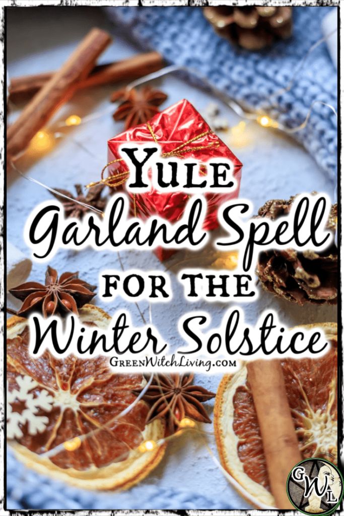 yule garland spell for the winter solstice with orange slices and cinnamons