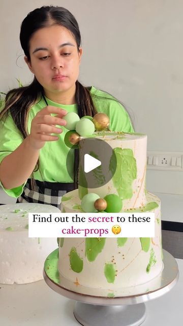 a woman decorating a cake with green icing