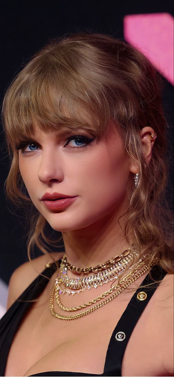 a close up of a person wearing a necklace and choker with an earring