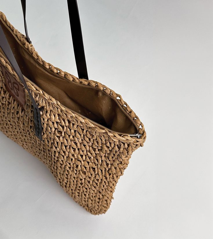 Embark on a journey of coastal elegance with our stunning Aria woven raffia tote, embodying the essence of Mediterranean living. Meticulously handcrafted with detailed raffia weaving and featuring sturdy brown handles, this tote exudes an aura of refined sophistication. Embrace the enchanting spirit of the Mediterranean with this indispensable accessory, a harmonious fusion of craftsmanship and style destined to captivate admirers.