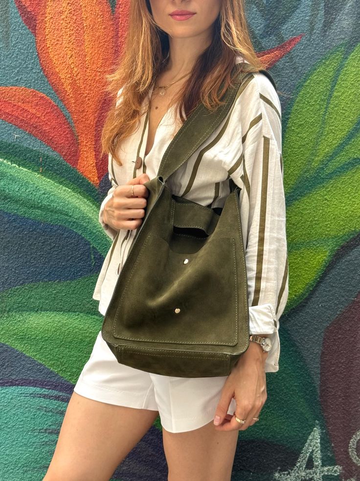 Army green slouch bag with interior and front pockets in genuine suede leather is handcrafted  for an every day use.  Every detail of this shopper suede bag emphasizes its owners refinement. The bag has unique style with accessories and color specific to that bag. You won't find another bag exactly like it. *Elegant and stylish, perfect jewel for every woman. * Design of this bag in completely made by us. *Highest quality natural suede leather. *Enough space to store everyday items, such as a wallet, phone, keys, Make up kit, notebook, book and even more items. *Light to carry. *No lining. *Magnetic closure. *Two interior pockets with button snap closing mechanism and 1 large interior pocket with zipper. *Two exterior, front pockets separated from  each other with button snaps, you can use Chic Suede Bag For On-the-go, Suede Shoulder Bag With Adjustable Strap For On-the-go, Green Satchel With Leather Handles For On-the-go, Green Hobo Bag With Leather Handles For On-the-go, Green Shoulder Bag For On-the-go, Chic Suede Bucket Bag For Everyday, Chic Suede Hobo Bag, Chic Shoulder Bag With Suede Lining And Double Handle, Chic Double Handle Shoulder Bag With Suede Lining