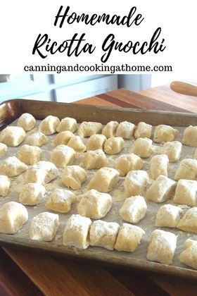 homemade ricotta gnocchi on a baking sheet ready to go into the oven