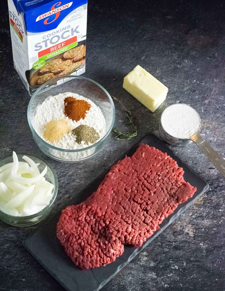 meat, cheese and other ingredients on a cutting board