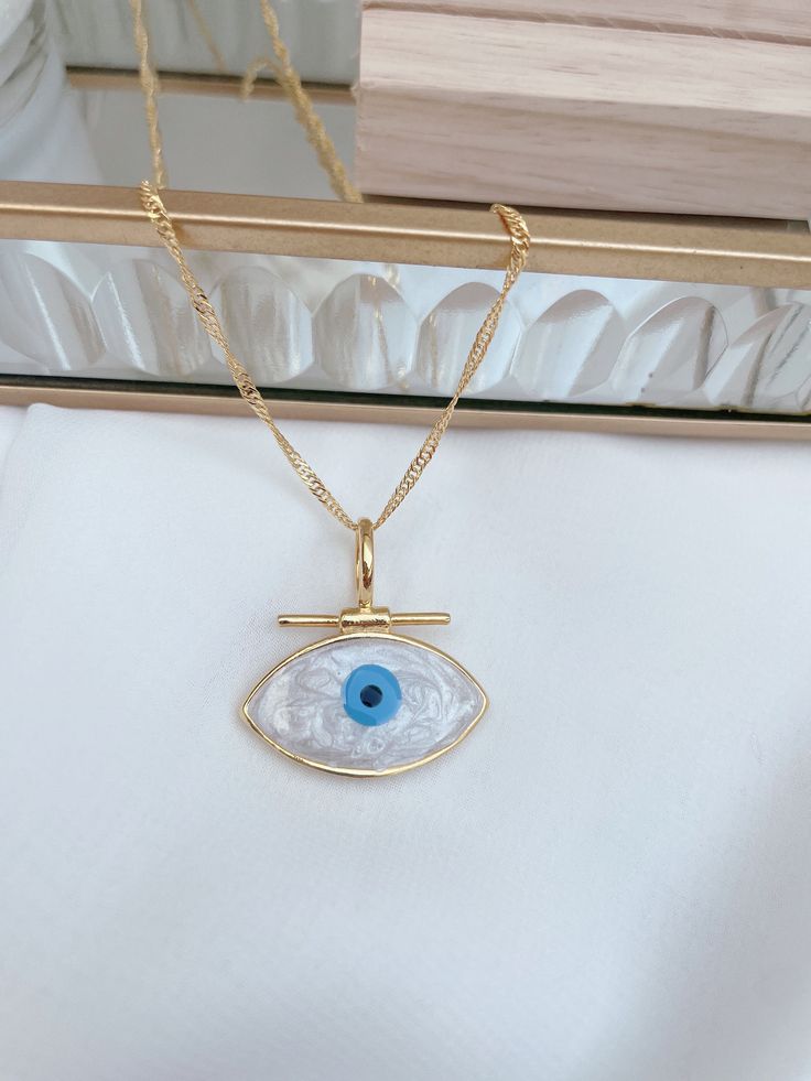 Nazar necklace, evil eye, Evim Eye 14k gold plated The chain shown is 45 cm long. This beautiful necklace is an eye-catcher for special appearances for special people. Also perfect as a gift for your loved one on Valentine's Day. Chain length 45 cm Pendant and chain 14k gold plated Please avoid situations where your jewelry comes into contact with soaps, lotions, hairspray or other chemicals as these can discolor and damage your jewelry. All of the necklaces' clasps are super easy to open so you Spiritual Gold Eye-shaped Necklace, Gold Evil Eye Pendant Charm Necklace, Blue Gold-plated Chain Necklace As Gift, Blue Gold Plated Chain Necklace As Gift, Gold-plated Evil Eye Amulet Necklace, Gold Plated Evil Eye Pendant Charm Necklace, Gold Plated Evil Eye Charm Necklace Gift, Blue Necklaces With Diamond Eyes As Gift, Gold Plated Evil Eye Amulet Necklace