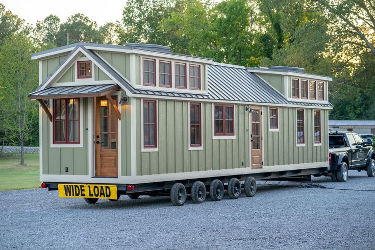 a tiny house is being towed by a truck