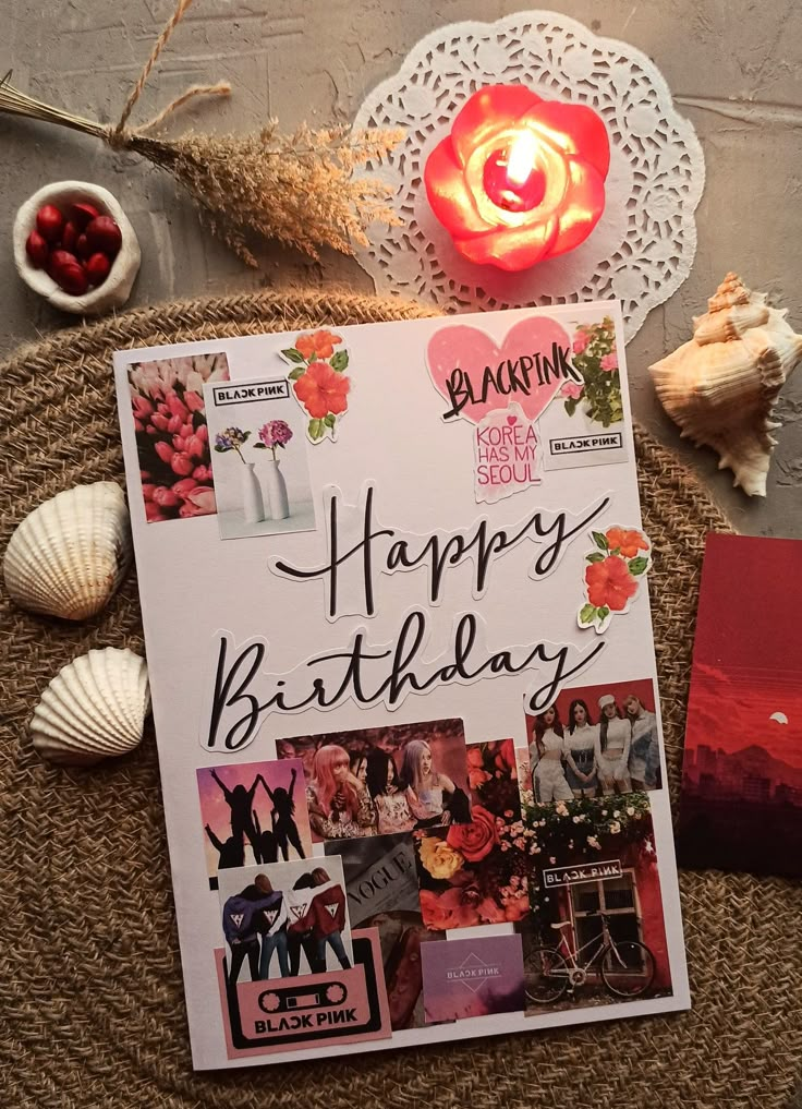 a birthday card sitting on top of a table next to candles and seashells