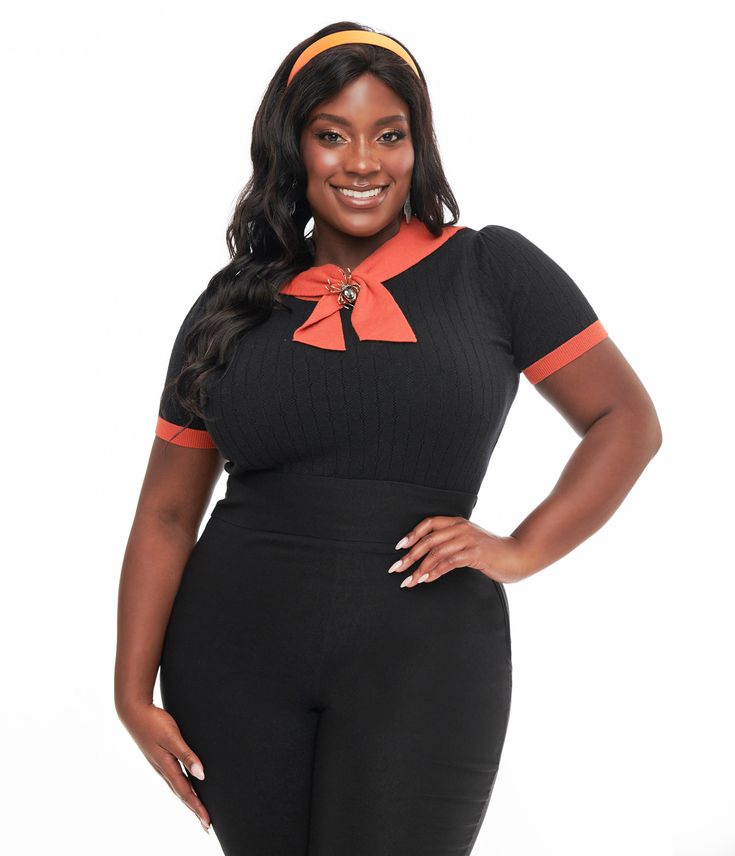 This 1950s inspired top from Unique Vintage is a sweet separate for a vintage dame, crafted in a soft black knit with eyelet details and a contrasting orange trim. Complete with a black self-tie neck tie, short sleeves, and removable spider brooch pin!.Available in sizes XS-5X while supplies last. Retro Orange Short Sleeve Tops, Spooky Short Sleeve Orange Shirt, Retro Halloween Short Sleeve Tops, Orange Spider, Soft Black, Black Knit, Park City, Unique Vintage, Neck Tie