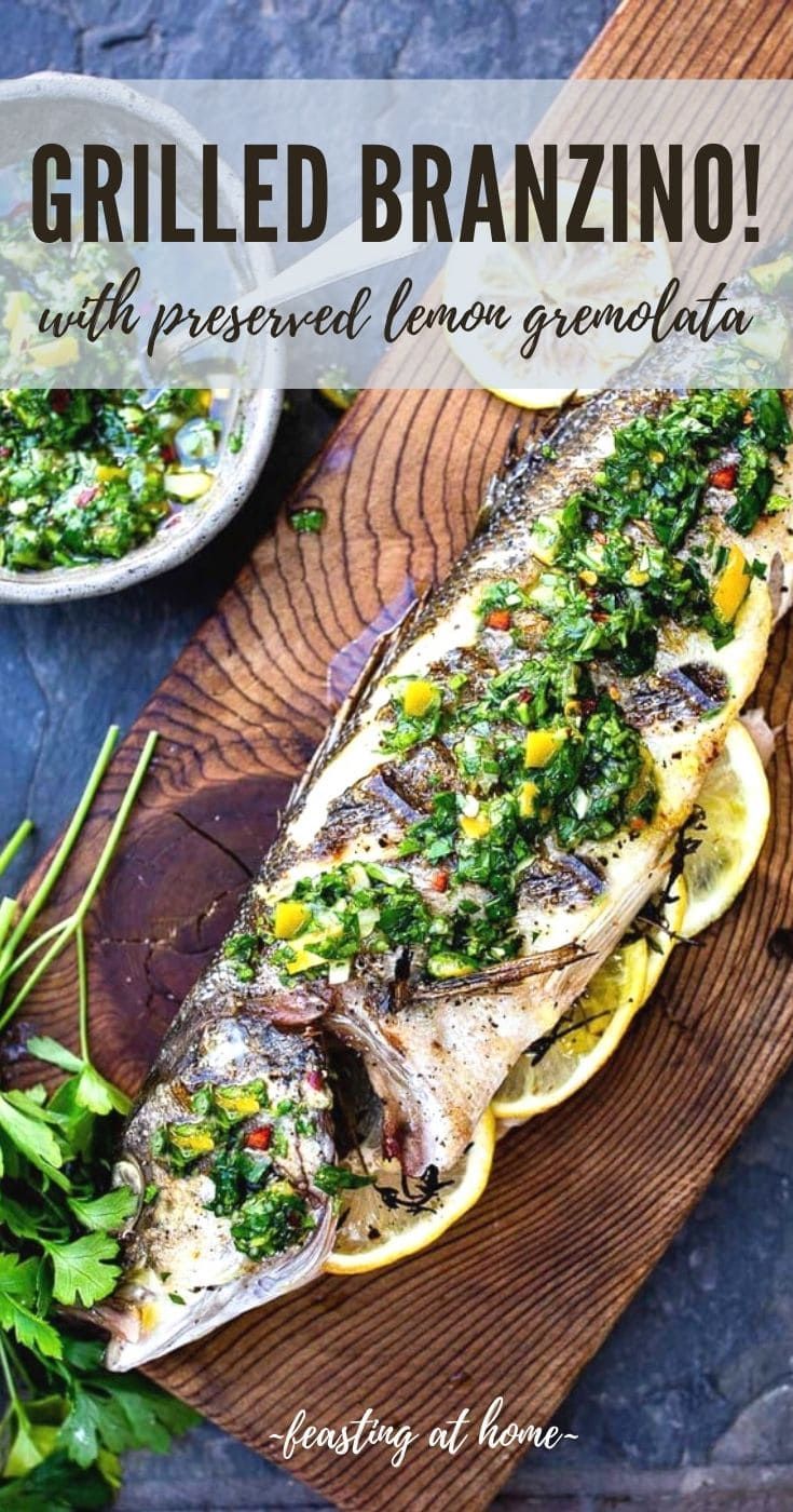 grilled brazilian fish with fresh lemon and parsley garnish