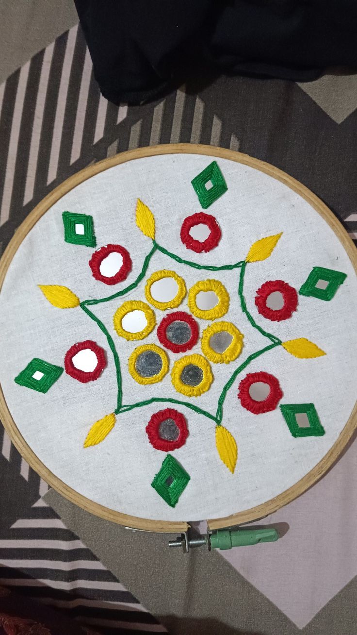 an embroidery project is shown on the table