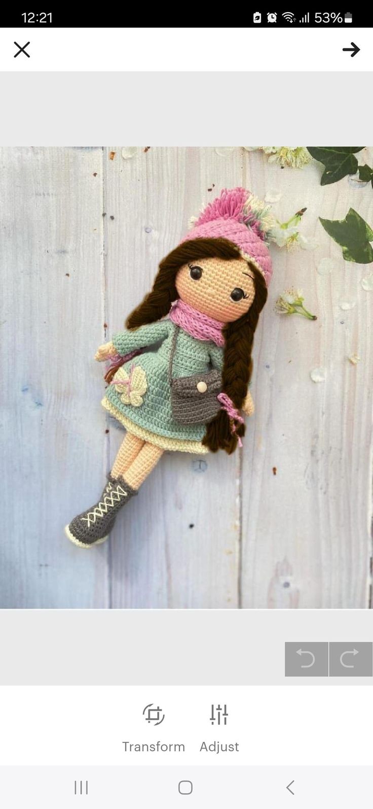 an image of a doll hanging on a wall with flowers in the background and text that reads, free crochet pattern