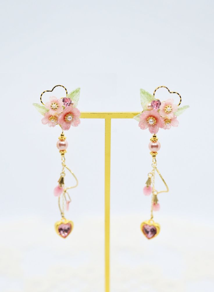 Sakura Blossom Swavorski Heart Crystal Earrings  🌼All handmade  ❀Color❀  Pink  ❀Size❀  3-4cm per earring  ❀Material❀  Crystal  ❀Features❀  Handmade by pure hands, using 18k gold-coated earrings, hypoallergenic and comfortable  ❀Product Maintenance❀  Do not directly contact with alcohol, use paper towel/makeup brush to wipe gently when in contact with water  ❀Other Platforms❀ Instagram @yisha_0u0  @yisha_groceries Youtube @洌玉Lieyu Pink Clip-on Flower Earrings For Gift, Pink Flower Shaped Pierced Earrings, Pink Flower-shaped Earrings For Valentine's Day, Pink Clip-on Earrings As Gift, Handmade Pink Double Heart Earrings, Pink Heart Beads Earrings For Gifts, Pink Flower-shaped Clip-on Earrings, Heart-shaped Clip-on Earrings As Gift, Heart-shaped Clip-on Jewelry For Valentine's Day