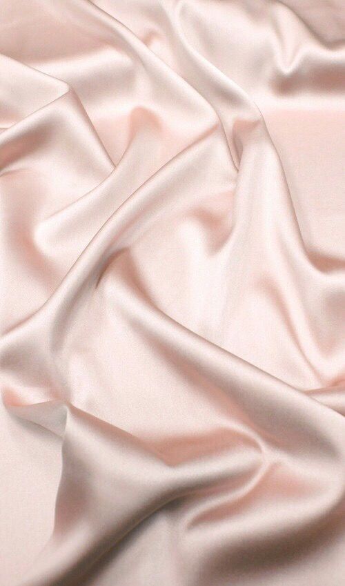 a close up view of a pink satin fabric