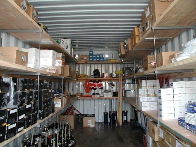 the inside of a storage room with lots of boxes and other items on shelving