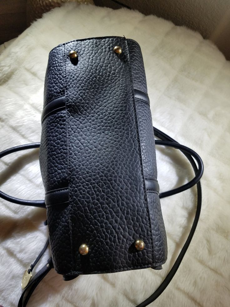 "Featuring this vintage Authentic Black Leather London Fog Handbag with long shoulder strap and Gold Tone metal hardware. The liner is in a Beige with Black lines going sideways design. There are 4 pockets in the interior while just 1 is outside on the front side. The purse does have 2 top handles and a Black zipper to protect your valuables. There is a metal hang tag with the hallmark that reads \"EST 1923 London Fog Authentic\". The purse is in excellent condition and will arrive carefully pac Business Satchel With Brass Hardware And Double Handle, Top Handle Pebbled Leather Shoulder Bag With Branded Hardware, Vintage Crossbody Shoulder Bag With Branded Hardware, Business Shoulder Bag With Pebbled Leather And Branded Hardware, Business Shoulder Bag With Branded Hardware In Pebbled Leather, Business Shoulder Bag With Branded Hardware And Pebbled Leather, Classic Black Satchel With Metal Hardware, Classic Crossbody Satchel With Branded Hardware, Classic Satchel With Branded Hardware For Daily Use