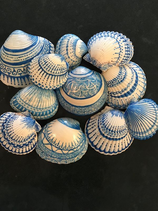 several blue and white vases sitting on top of each other