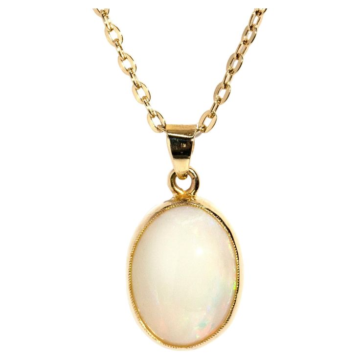 Crafted in 18 carat yellow gold, this adorable pendant features a lovely solid oval Australian crystal opal afire with alluring green and orange play of colour and set into an elegant milgrain rubover setting. Her name is The Cordy Pendant. She is threaded with an elegant cable chain and is ever-so-comfortable to wear, a perfect adornment fit for any time or place. The Cordy Pendant & Chain Gem Details The solid Australian white base opal display subdued flashes of orange and green play of colou Green Play, Australian Opal Pendant, Crystal Opal, Orange And Green, Australian Opal, Opal Crystal, Opal Pendants, Vintage Jewellery, Free Jewelry