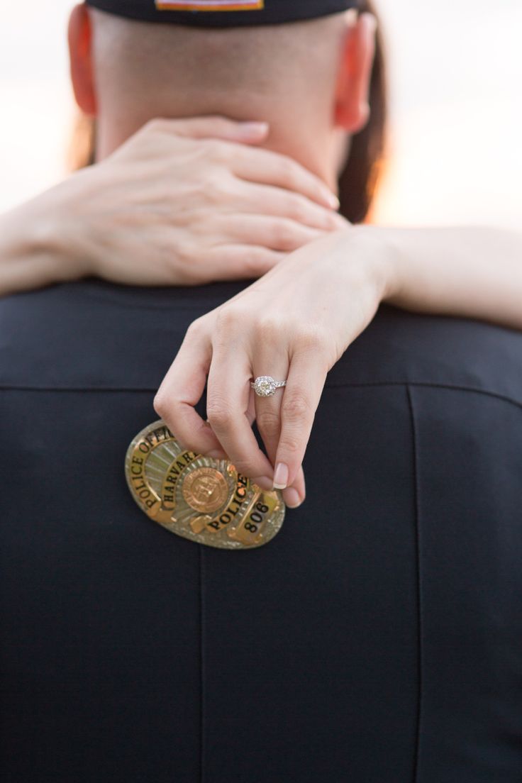 a woman holding onto the back of a man's neck with his hands on him