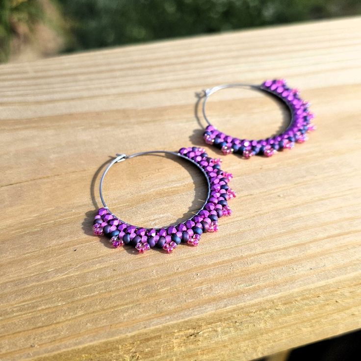 Hand woven seed bead hoop earrings created with fine glass seed beads and Fire-polished beads in shades of Pink delicately woven onto Stainless Steel hoops.     👉  Arrives in a gift box with bow, ready for giving. 🎁 👉  Measurements:  2 inches around. 👉  Lightweight and easy to wear 👉  304 Stainless Steel hoops 👉  Miyuki and Czech glass seed beads 👉  Thermally-fused extra strong thread For different colorways and styles, visit my shop:  https://www.etsy.com/shop/CyntheCreations ⭐  THINGS TO KNOW ABOUT BEADED JEWELRY:  While sealed for normal wear, glass beads are NOT WATERPROOF and should not be worn when swimming or bathing.      Pattern Design by Capital City Beads Small Hoop Beaded Earrings With Tiny Beads For Festival, Festival Small Hoop Earrings With Tiny Beads, Handmade Beaded Bracelets For Gifts, Small Hoop Beaded Earrings With Spacer Beads For Gifts, Small Hoop Beaded Earrings With Spacer Beads As Gift, Purple Beaded Earrings With Round Beads For Festival, Festival Hoop Earrings With Tiny Beads, Handmade Bohemian Hoop Beaded Bracelets, Hoop Earrings With Tiny Round Beads For Festivals