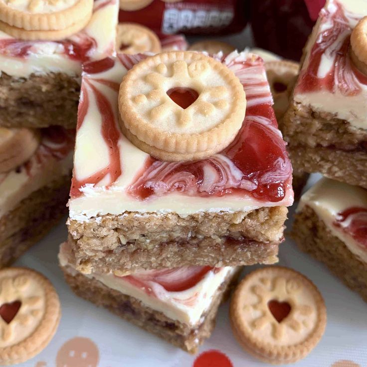 several desserts are stacked on top of each other with cookies and jelly in the middle